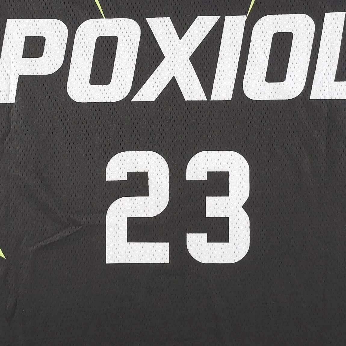Close-up of number 23 printed on a POXIOL basketball jersey