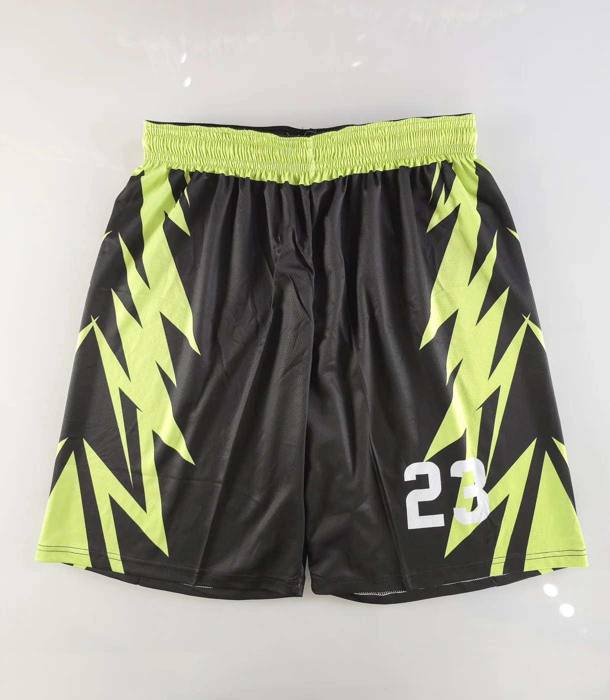 Front of matching black and neon green POXIOL basketball shorts